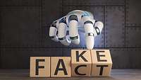 Eine Roboterhand dreht Holzklötze, wodurch die Worte "Fake" und "Fact" erscheinen