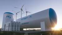 Großer Wasserstofftank mit der Aufschrift "Hydrogen H2 zero emission" vor drei Windrädern 